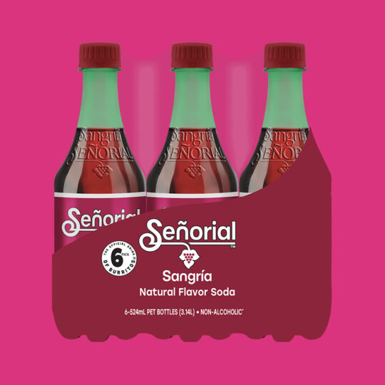 Sangría Señorial six-pack showcased against a bold pink background, highlighting its signature bottles and vibrant packaging.