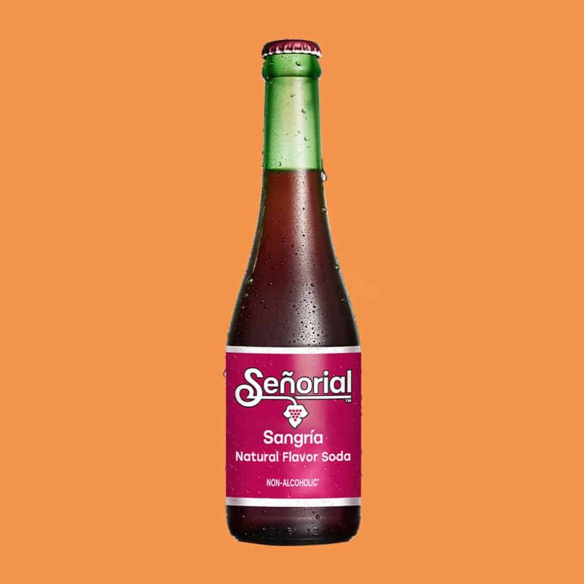 Sangria Senorial glass bottle with deep red soda, condensation details, and a vibrant label, presented as a refreshing premium non-alcoholic drink.