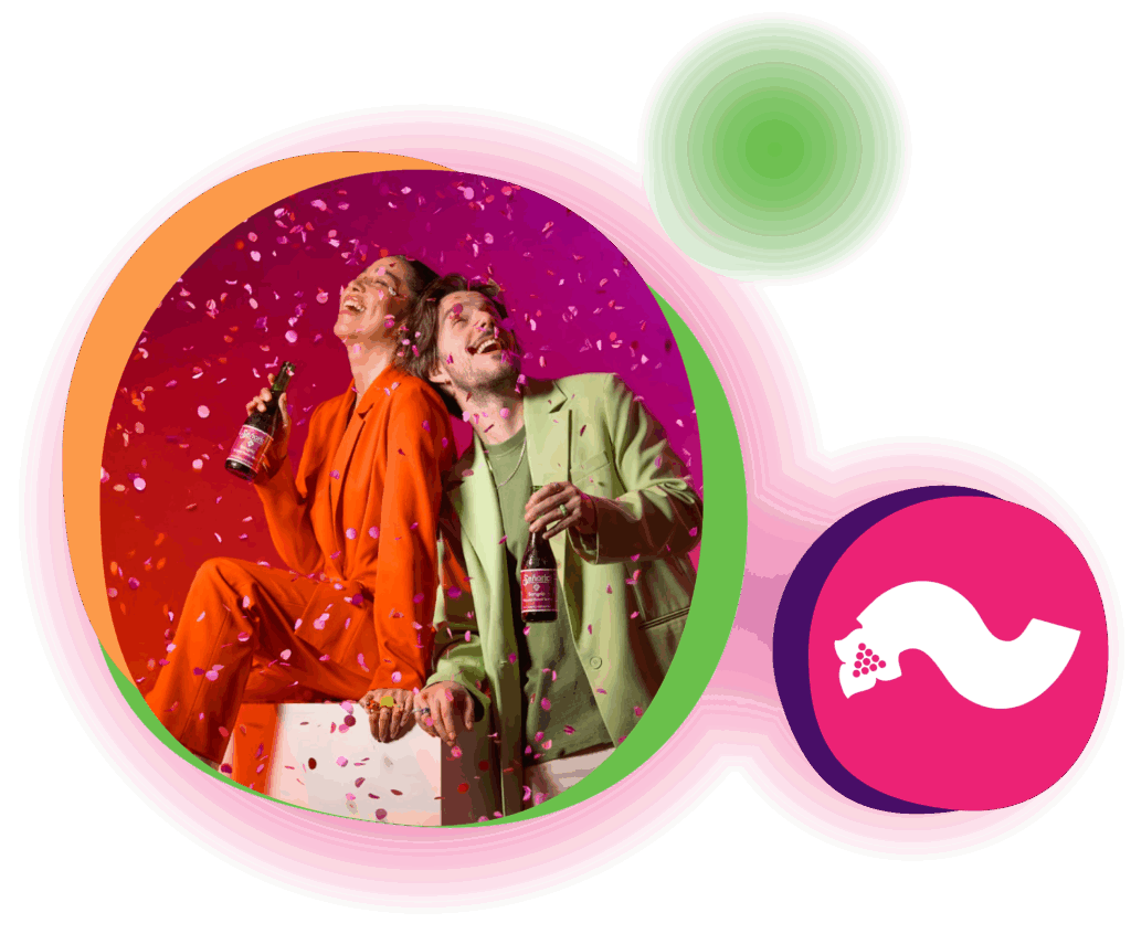 Two people celebrating with Sangría Señorial as colorful confetti falls around them, creating a vibrant, festive scene.